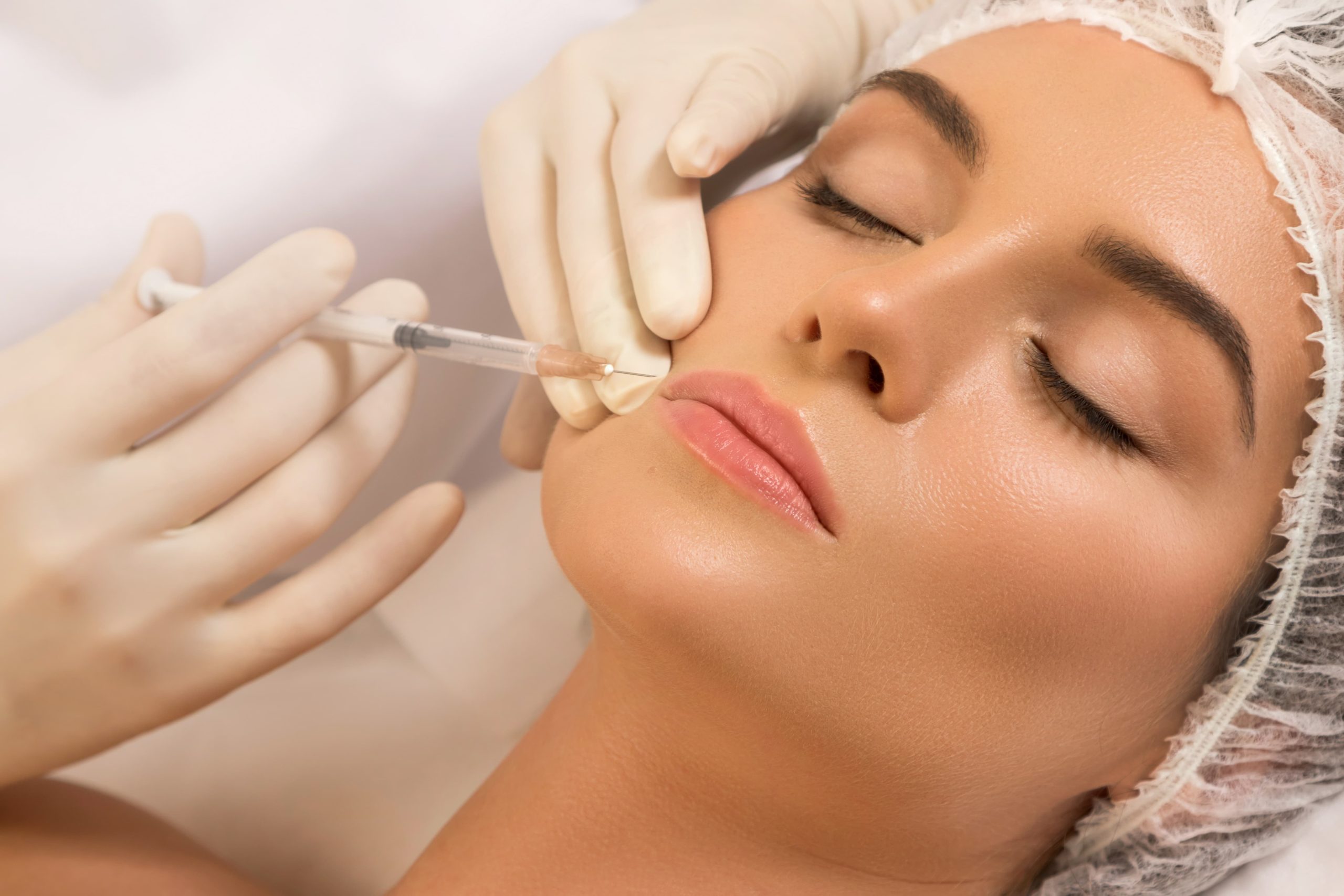 Closed-eye woman receiving Botox Treatment in San Diego, CA | Botoxie